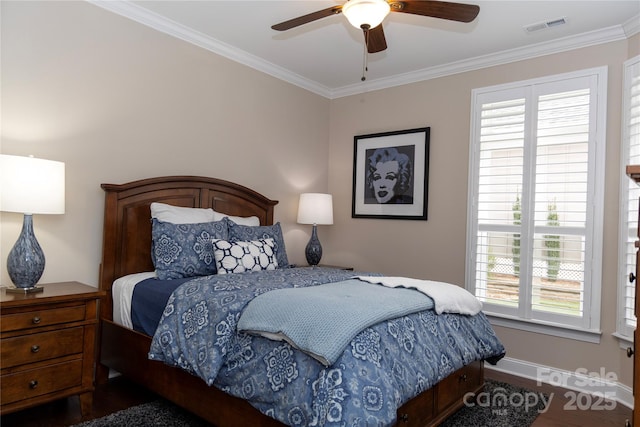 bedroom with ceiling fan, ornamental molding, visible vents, and baseboards