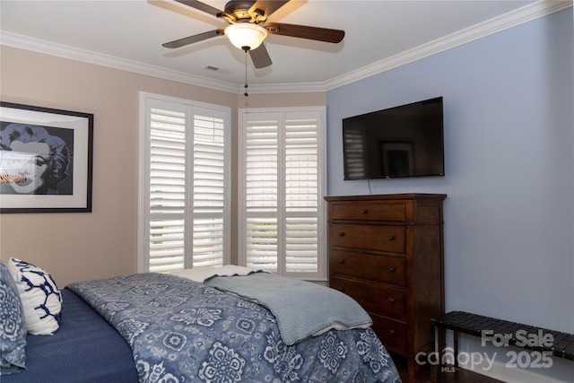 bedroom with a ceiling fan, visible vents, and crown molding