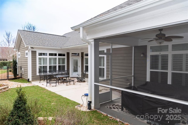 view of patio / terrace featuring a sunroom, fence, and ceiling fan