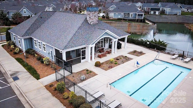 drone / aerial view featuring a residential view and a water view