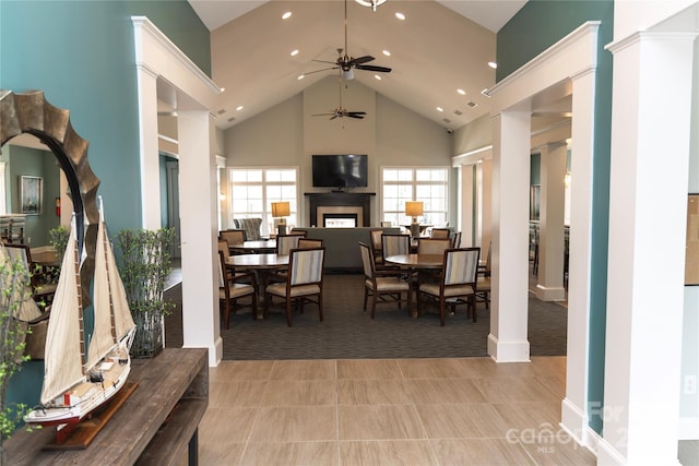 dining area featuring decorative columns, a fireplace, high vaulted ceiling, and recessed lighting