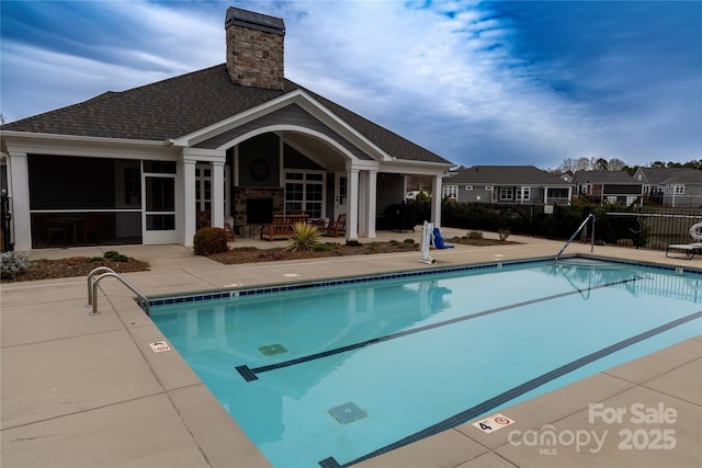 community pool featuring a patio and fence