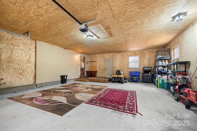 interior space with wood ceiling and a garage door opener