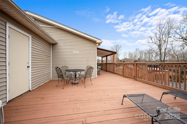 wooden terrace featuring outdoor dining area