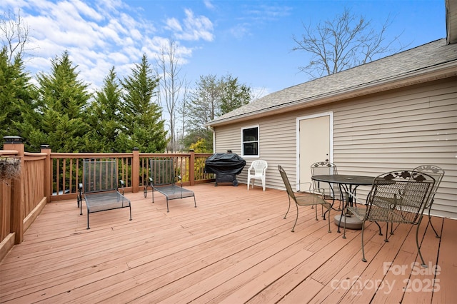 deck with outdoor dining area and area for grilling