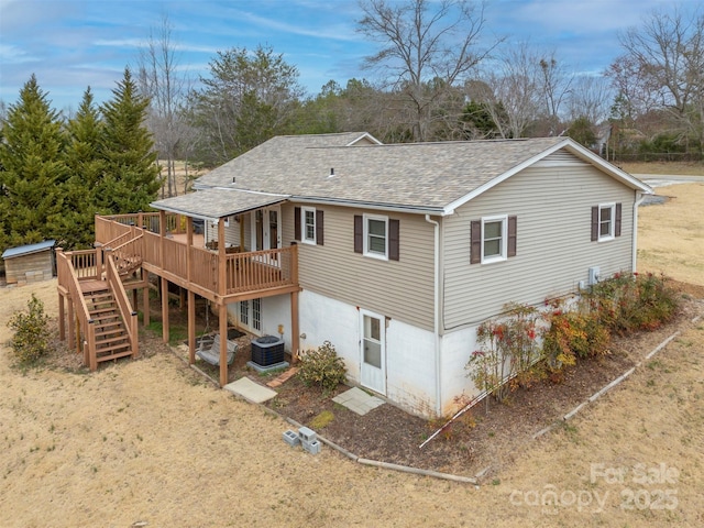 rear view of property with central AC, stairway, a wooden deck, and roof with shingles