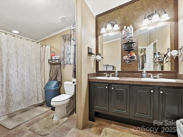 full bathroom featuring toilet, crown molding, a textured ceiling, and a sink