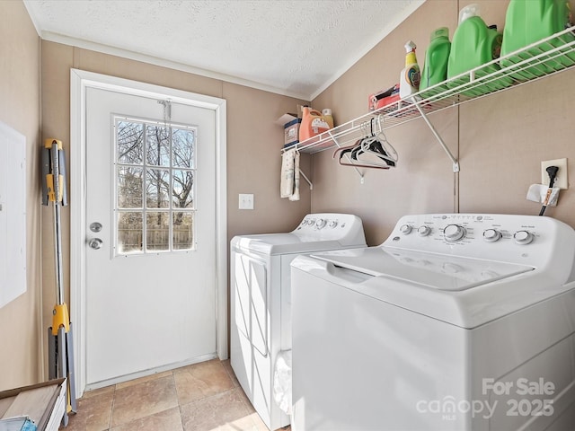 laundry room featuring laundry area, washer and clothes dryer, and a textured ceiling