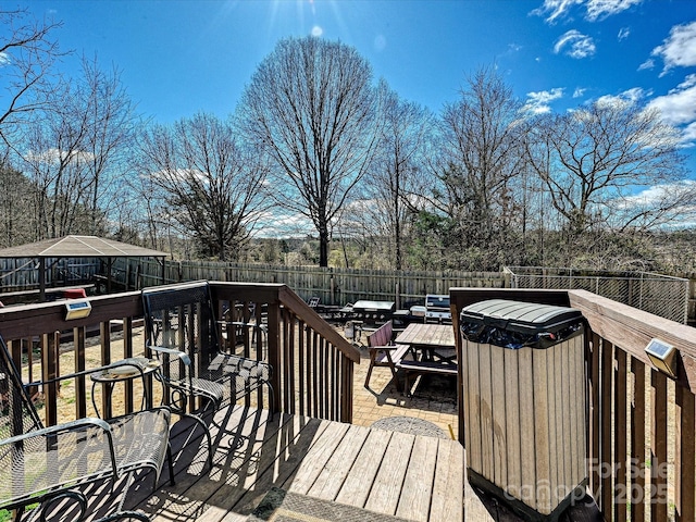 wooden deck featuring a fenced backyard