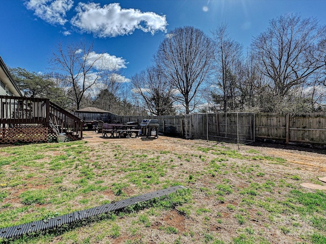 view of yard featuring a deck and a fenced backyard