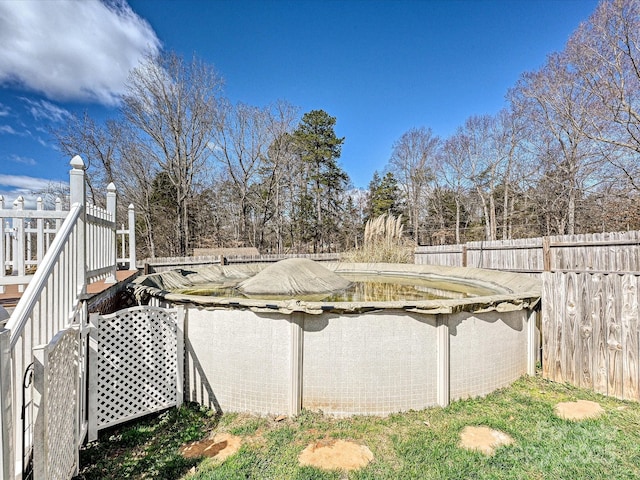 view of pool featuring fence