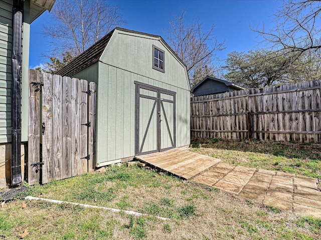 view of shed featuring fence