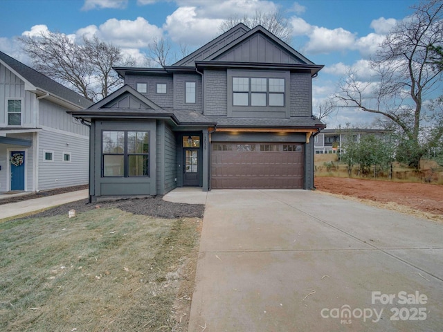 view of front of home featuring driveway, board and batten siding, an attached garage, and roof with shingles