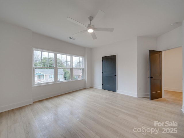 unfurnished bedroom with light wood finished floors, baseboards, visible vents, and ceiling fan