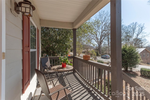 balcony featuring a porch and a sunroom