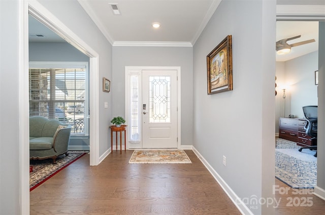 entryway featuring visible vents, plenty of natural light, wood finished floors, and crown molding