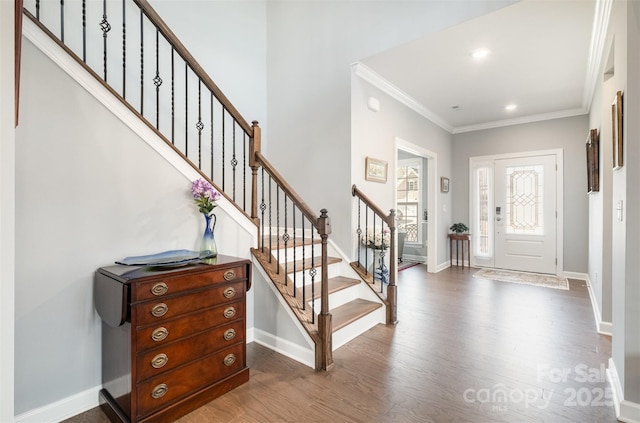 entryway featuring recessed lighting, dark wood-type flooring, baseboards, and ornamental molding