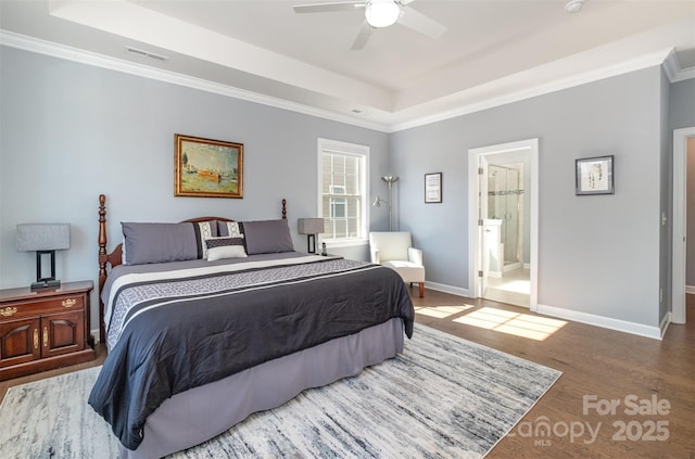 bedroom featuring baseboards, a raised ceiling, visible vents, and ornamental molding