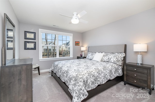 bedroom with visible vents, baseboards, ceiling fan, and carpet flooring