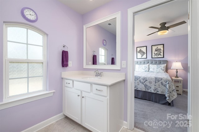 bathroom featuring vanity, baseboards, ceiling fan, tile patterned floors, and connected bathroom