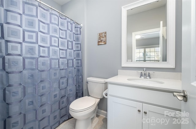 bathroom with toilet, vanity, and a shower with shower curtain