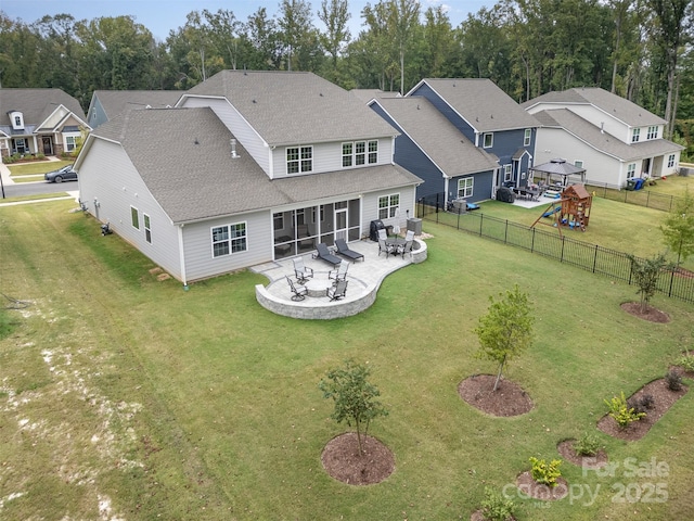 back of property with a fenced backyard, a yard, a patio, and roof with shingles