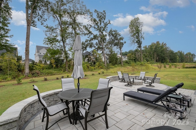 view of patio / terrace with outdoor dining area and a fire pit