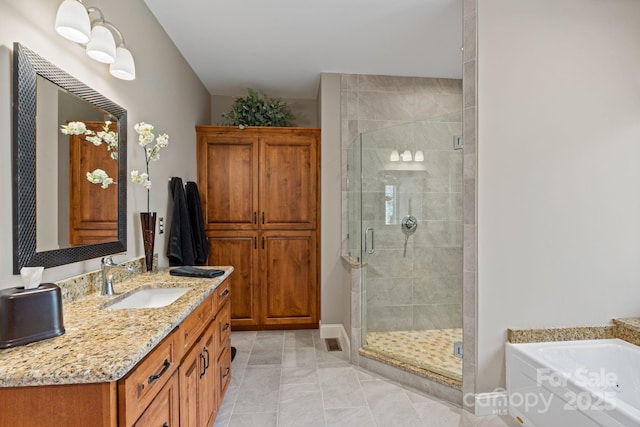 bathroom featuring tile patterned floors, a shower stall, vanity, and a garden tub