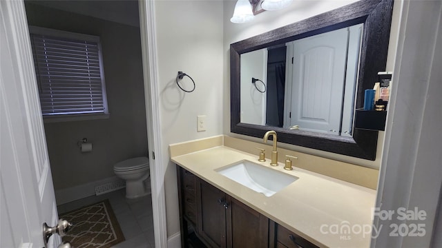 bathroom featuring tile patterned floors, visible vents, toilet, baseboards, and vanity