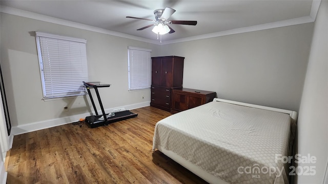 bedroom featuring wood finished floors, a ceiling fan, baseboards, and ornamental molding