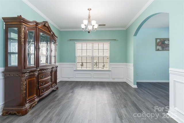 unfurnished dining area with a wealth of natural light, visible vents, arched walkways, and dark wood-style flooring