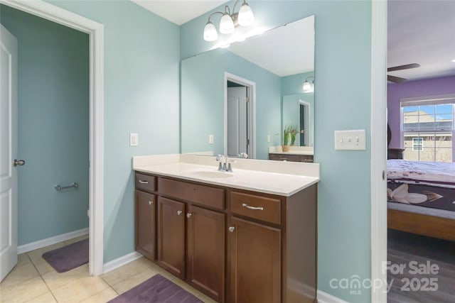 ensuite bathroom with vanity, a ceiling fan, baseboards, tile patterned floors, and connected bathroom