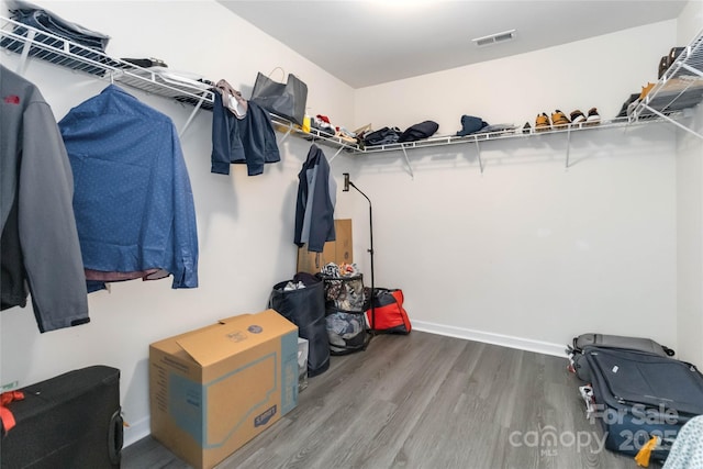 walk in closet featuring visible vents and wood finished floors