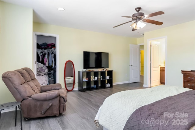 bedroom with a closet, a ceiling fan, baseboards, and wood finished floors