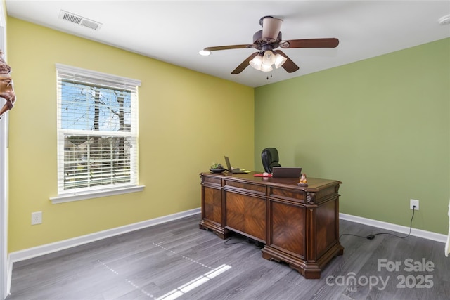 office area with visible vents, ceiling fan, baseboards, and wood finished floors