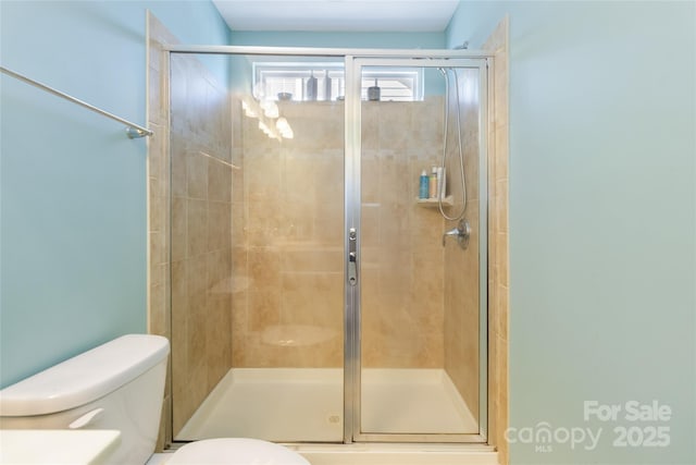 full bathroom with toilet and a shower stall