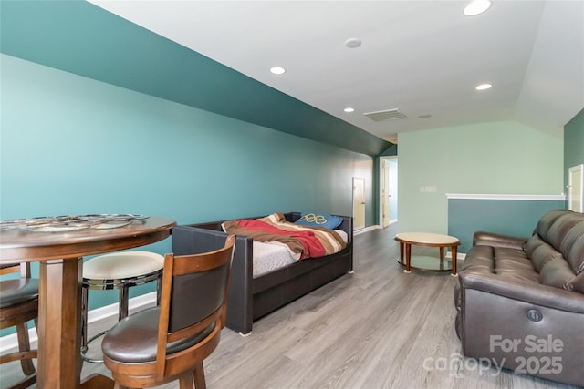 bedroom with wood finished floors, visible vents, baseboards, lofted ceiling, and recessed lighting