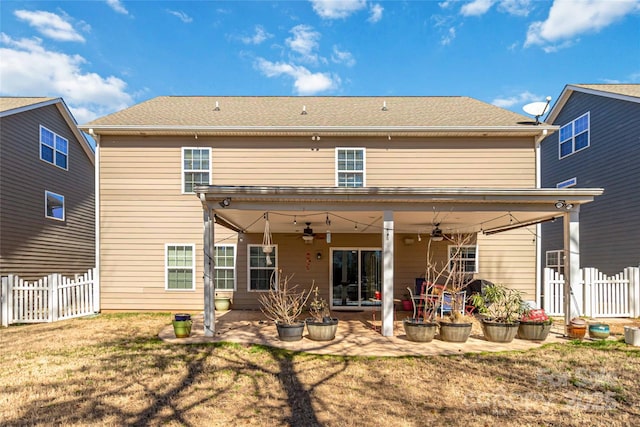 rear view of house with a patio, a lawn, ceiling fan, and fence