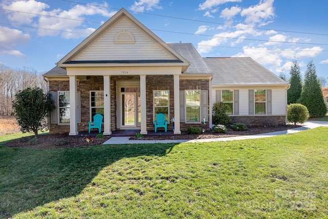 greek revival house featuring a front yard and a porch