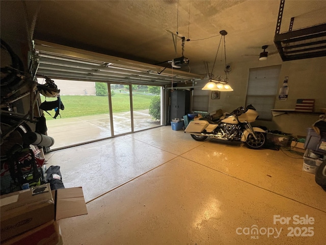 7034 Pin Oaks Dr, Denver, NC 28037 - garage featuring a garage door opener and a ceiling fan