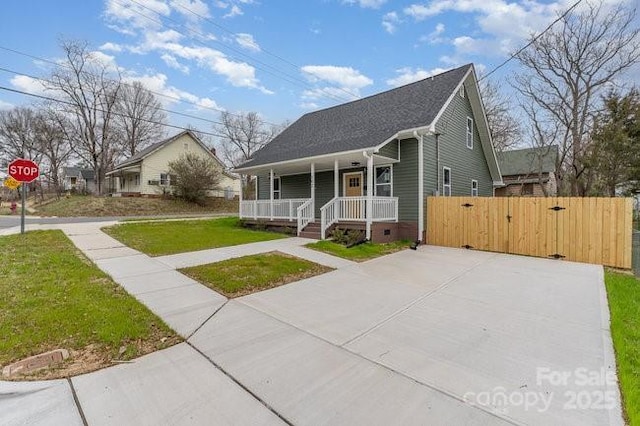 bungalow-style house featuring crawl space, covered porch, a gate, and a front lawn