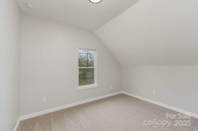 bonus room with carpet floors, baseboards, and lofted ceiling