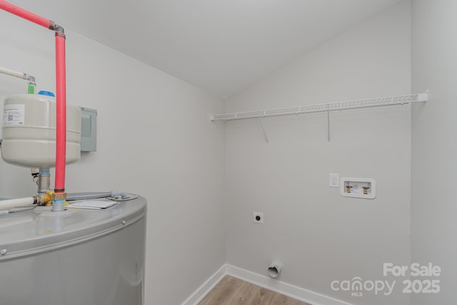laundry room with laundry area, hookup for a washing machine, electric dryer hookup, light wood finished floors, and water heater