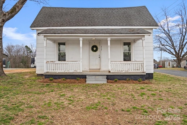 bungalow with a shingled roof and covered porch