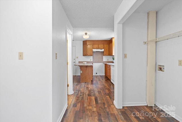 hallway featuring a textured ceiling, baseboards, and dark wood-type flooring