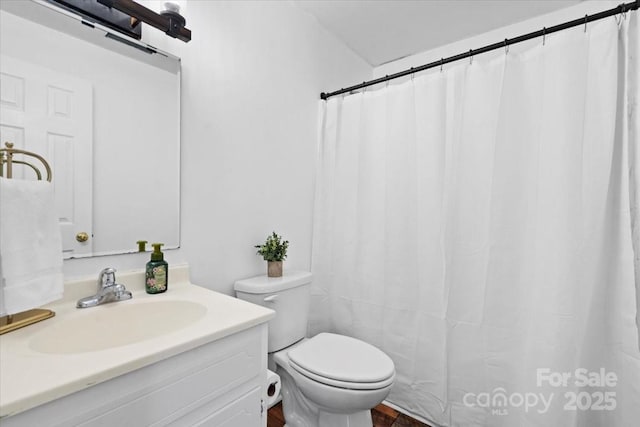 full bathroom featuring vanity and toilet