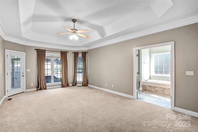 spare room featuring carpet flooring, visible vents, baseboards, and a tray ceiling