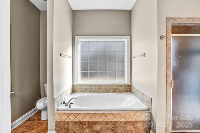 bathroom with a garden tub, toilet, a stall shower, and tile patterned flooring