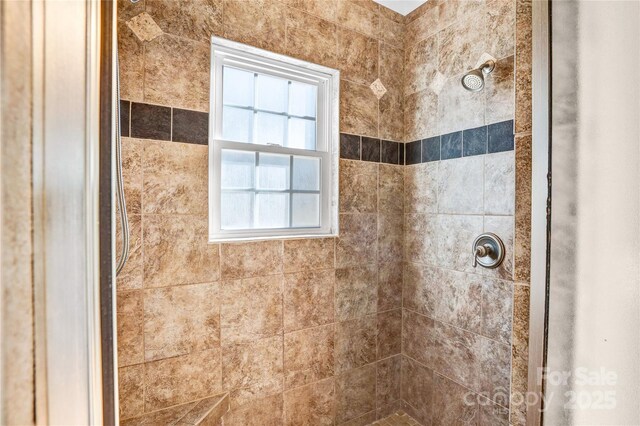 bathroom with a tile shower