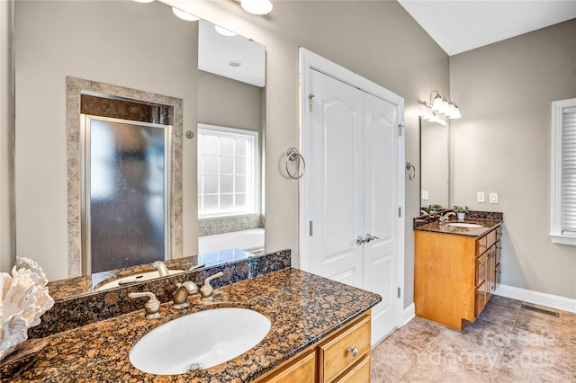 bathroom with a sink, visible vents, two vanities, and a shower stall